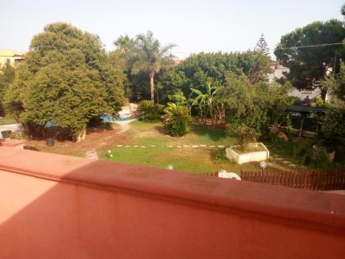 a view of a garden from a balcony at B&B Leonida in Taranto