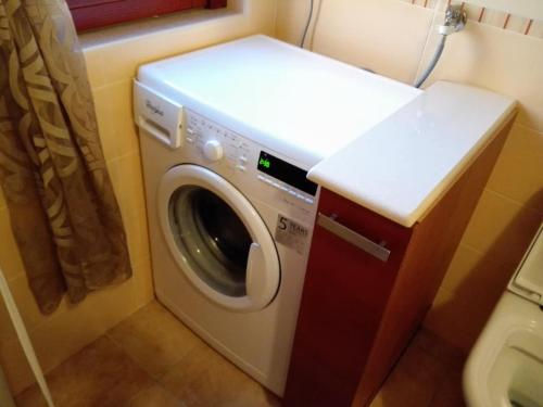 a washing machine in a small bathroom with a counter at La Villetta di Andrè in Termoli