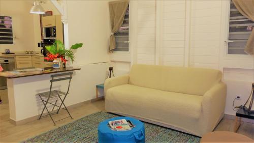 a living room with a couch and a table at La Ferme des Etangs in Rivière-Salée