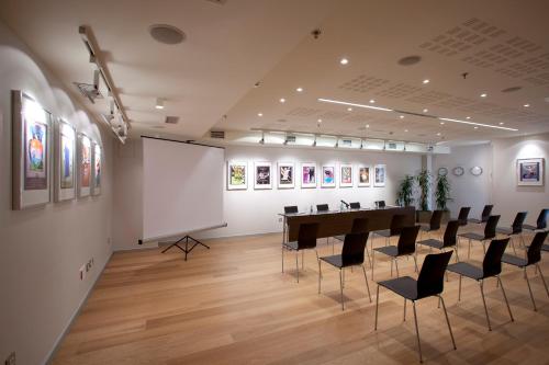 a conference room with a long table and chairs at Hotel Zinema7 in Donostia-San Sebastián