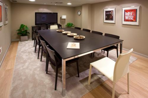 a dining room with a black table and chairs at Hotel Zinema7 in Donostia-San Sebastián
