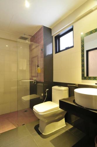 a bathroom with a toilet and a sink and a shower at At 24 Boutique Hotel in Nakhon Si Thammarat
