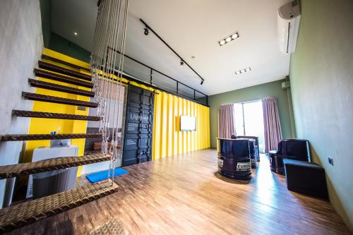 a room with a staircase and a living room with yellow walls at Urban in Kaohsiung