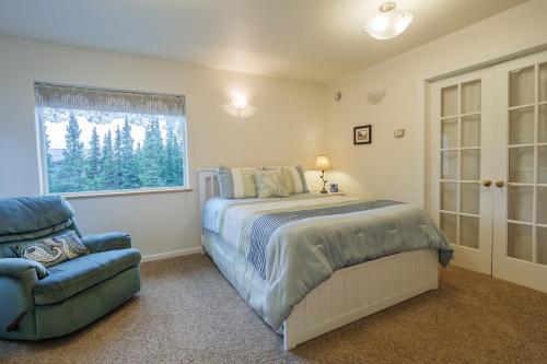 a bedroom with a bed and a chair and a window at Denali Primrose Bed & Breakfast in Healy