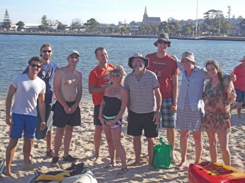 a group of people posing for a picture on the beach at Dolphin Retreat Bunbury in Bunbury