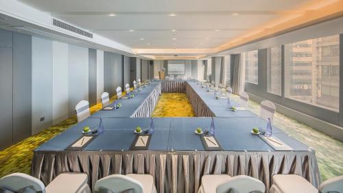 a large conference room with a long table with chairs at Shanghai Pagoda INNO Hotel in Shanghai