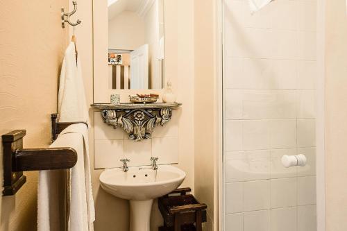a small bathroom with a sink and a toilet at Goble Palms Guest Lodge & Urban Retreat in Durban