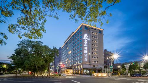 a tall building with a sign on the side of it at Royal Chiayi Hotel in Chiayi City