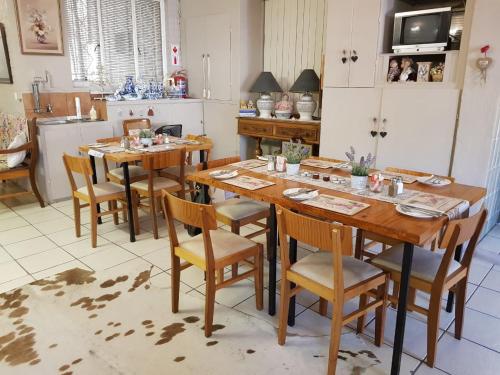a kitchen with a table and chairs in a room at Lavender Lane in Ladysmith
