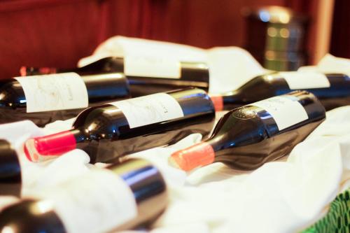 a bunch of bottles of wine on a table at Tchero Hotel in Douala