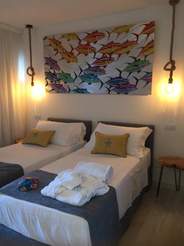 Postel nebo postele na pokoji v ubytování Geco di Giada Art Suites - Adult Only