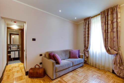 a living room with a couch with purple pillows at Solo Experience Hotel in Florence