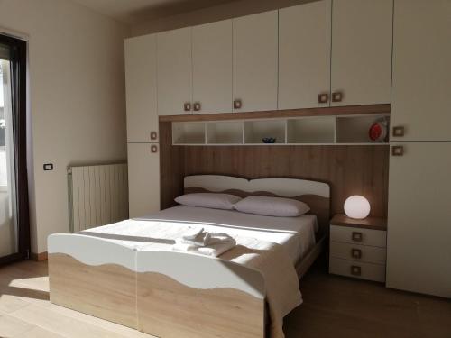 NevianoにあるCasa Ninìのベッドルーム1室(大型ベッド1台、木製ヘッドボード付)