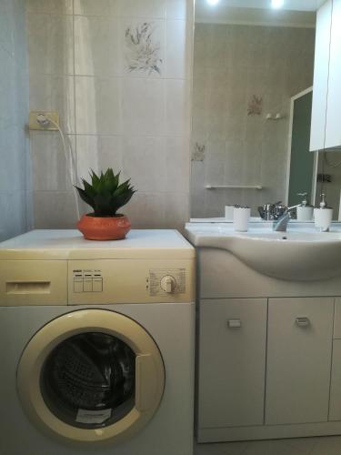 a washing machine in a bathroom with a sink at Villa Delux in Correzzola