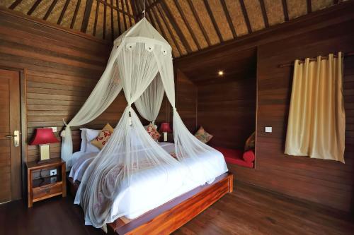 เตียงในห้องที่ Dream Beach Cottages