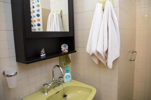 a bathroom with a sink and a mirror and towels at Anemos in Spetses