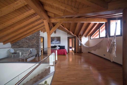 a large room with wooden ceilings and a fireplace at La Morada de Andoin in Andoín