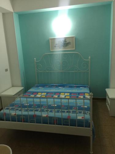 a bedroom with a bed with a blue wall at Villa Irene in Vieste
