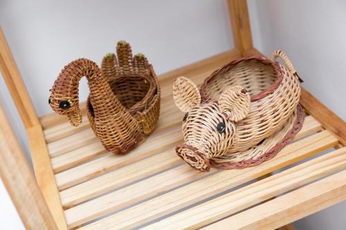 a wooden shelf with two wicker baskets on it at Bence Apartman in Tiszabábolna