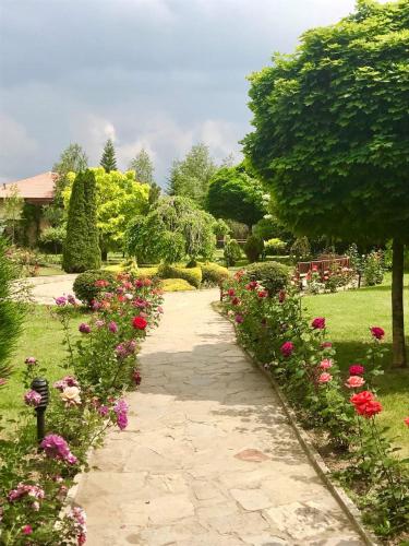 a garden with flowers and a walkway at Tsarsko Selo Spa Hotel in Sofia