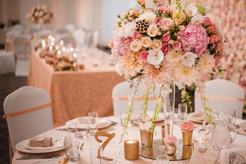 a table with a vase filled with pink and white flowers at Tsarsko Selo Spa Hotel in Sofia