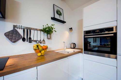 a kitchen with a counter with a bowl of fruit at Lakovich Sea view Apartments in Rovinj