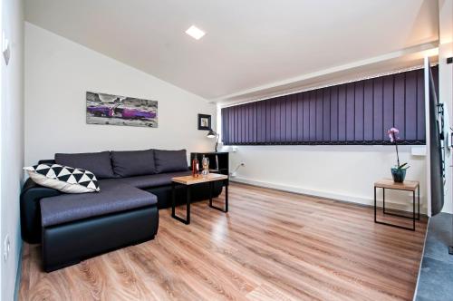 a living room with a couch and a table at Lakovich Sea view Apartments in Rovinj