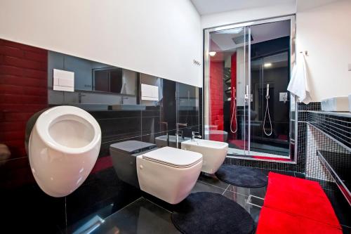 a bathroom with two toilets and a shower at Lakovich Sea view Apartments in Rovinj