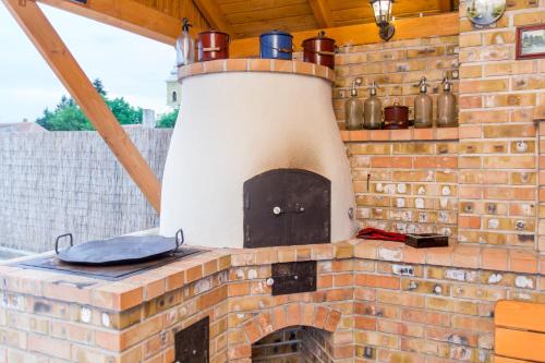 an outdoor brick oven with pots and pans on top at Bence Apartman in Tiszabábolna