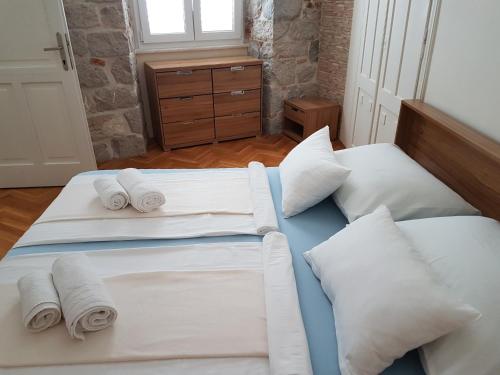 a bedroom with two beds with white sheets and pillows at Luxury Apartment Riva with a magnificient view in Split