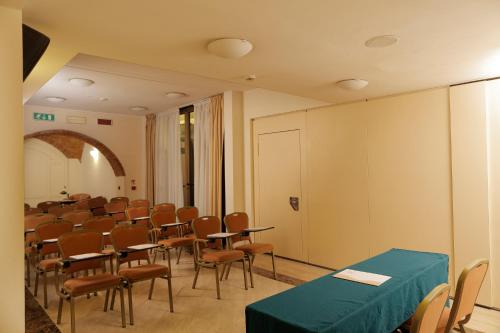 a room with rows of tables and chairs in it at Allegroitalia San Gallo Firenze in Florence