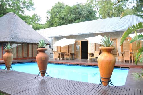 a pool with three large vases with plants in them at Farquhar Lodge in Ladysmith