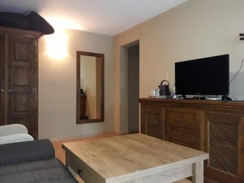 a living room with a flat screen tv on a wooden table at Zaara Estate Winery Hotel & SPA in Glavan