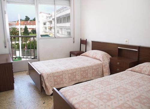 เตียงในห้องที่ Apartamentos Vacacionales Caracas
