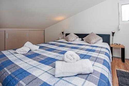 a bedroom with a bed with towels on it at Lakovich Sea view Apartments in Rovinj