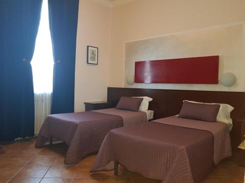 Un pat sau paturi într-o cameră la Hotel La Pendola