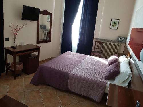 Cama ou camas em um quarto em Hotel La Pendola
