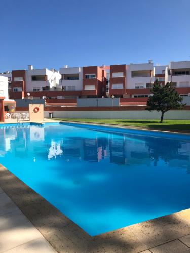 a large swimming pool in front of a building at Beach House Cabedelo in Viana do Castelo