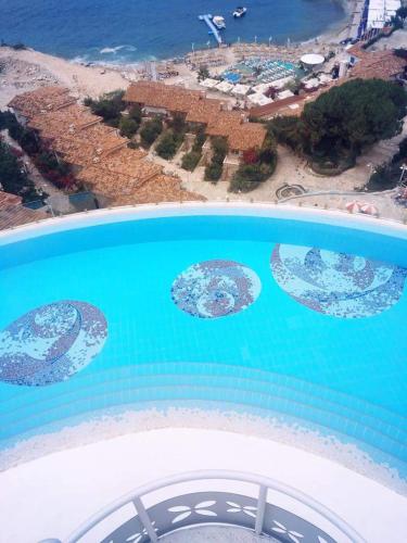 an aerial view of a pool of water with a beach at Bougainvill Sunset Villa in Sarandë