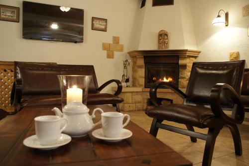 a living room with a table with a candle and chairs at Nowa - Ski SPA Hotel in Karpacz