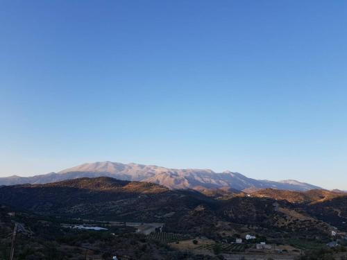 a view of a mountain range with snow covered mountains at Creta Star Apartments in Agia Galini