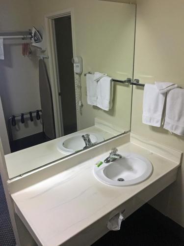 a bathroom with a sink and a mirror at FairBridge Extended Stay, a Kitchenette Hotel in Idaho Falls