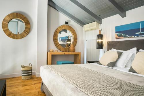 a bedroom with a large bed and a mirror at Avithos Resort Hotel in Svoronata
