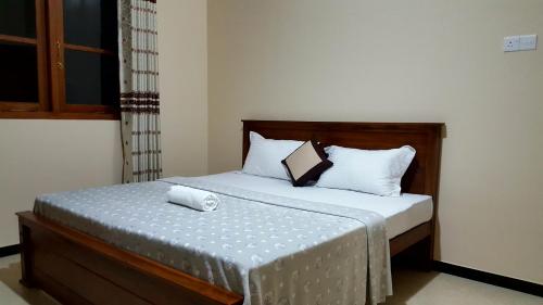 a bedroom with a bed with white pillows at Mount View Bungalow in Hatton