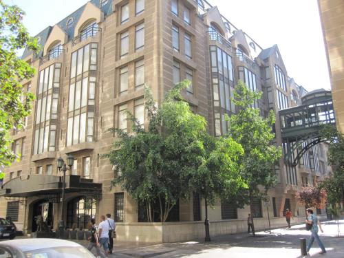 a large building with people walking in front of it at Hotel Fundador in Santiago