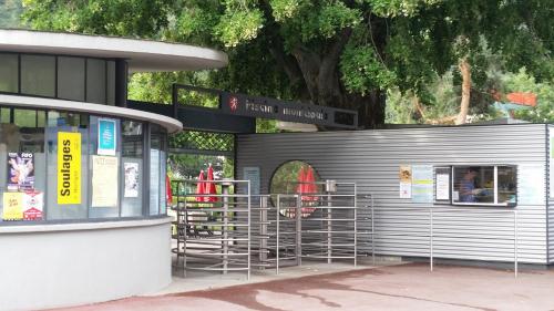 a building with metal racks in front of it at Motel des Sports Martigny in Martigny-Ville
