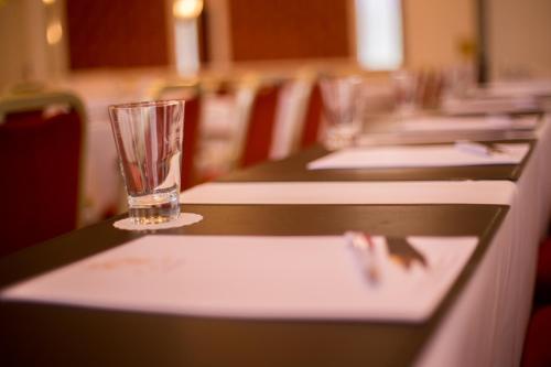 a row of empty glasses sitting on a table at Hotel Chemnitzer Hof in Chemnitz