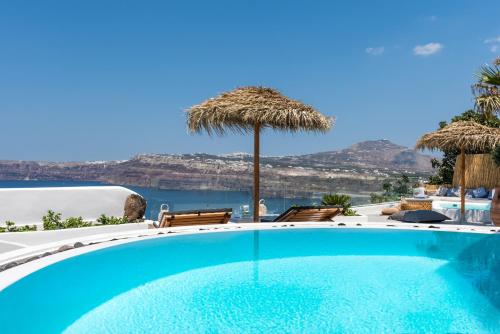 a swimming pool with a view of the ocean at Summer Lovers Villa in Akrotiri