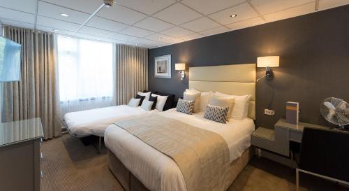 a hotel room with a large bed and two nightstands at The Barnstaple Hotel in Barnstaple