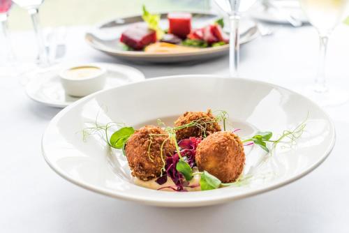 a white plate with some food on a table at The Barnstaple Hotel in Barnstaple